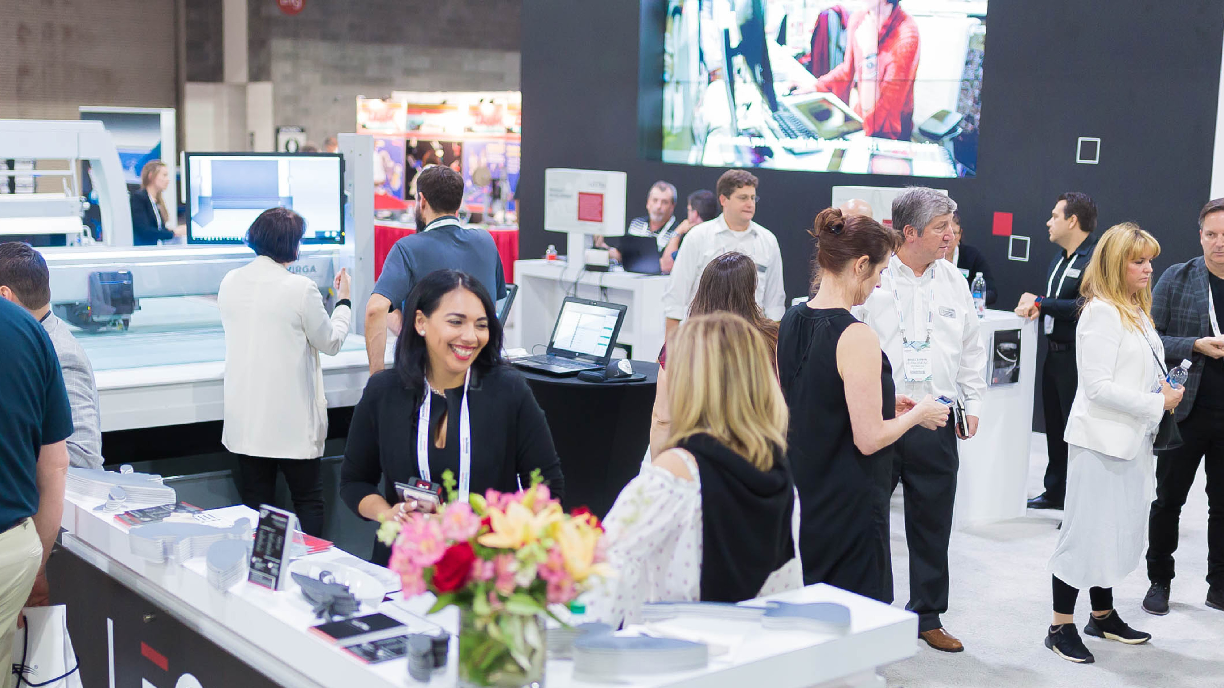 Attendees exploring diverse textile designs at a booth during Texworld New York.